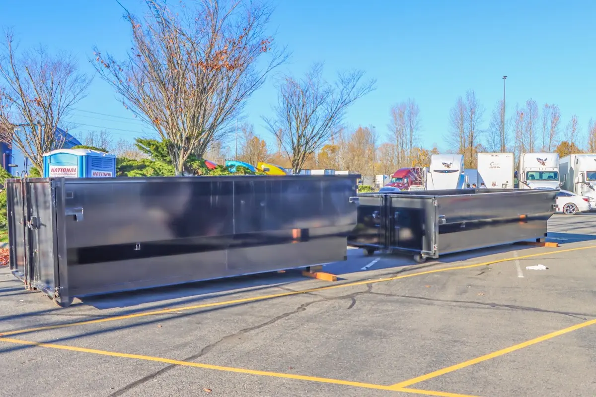 Professional dumpster rental service with roll-off container on residential driveway in Los Altos